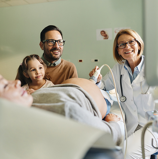 A family watches the results of an ultrasound.
