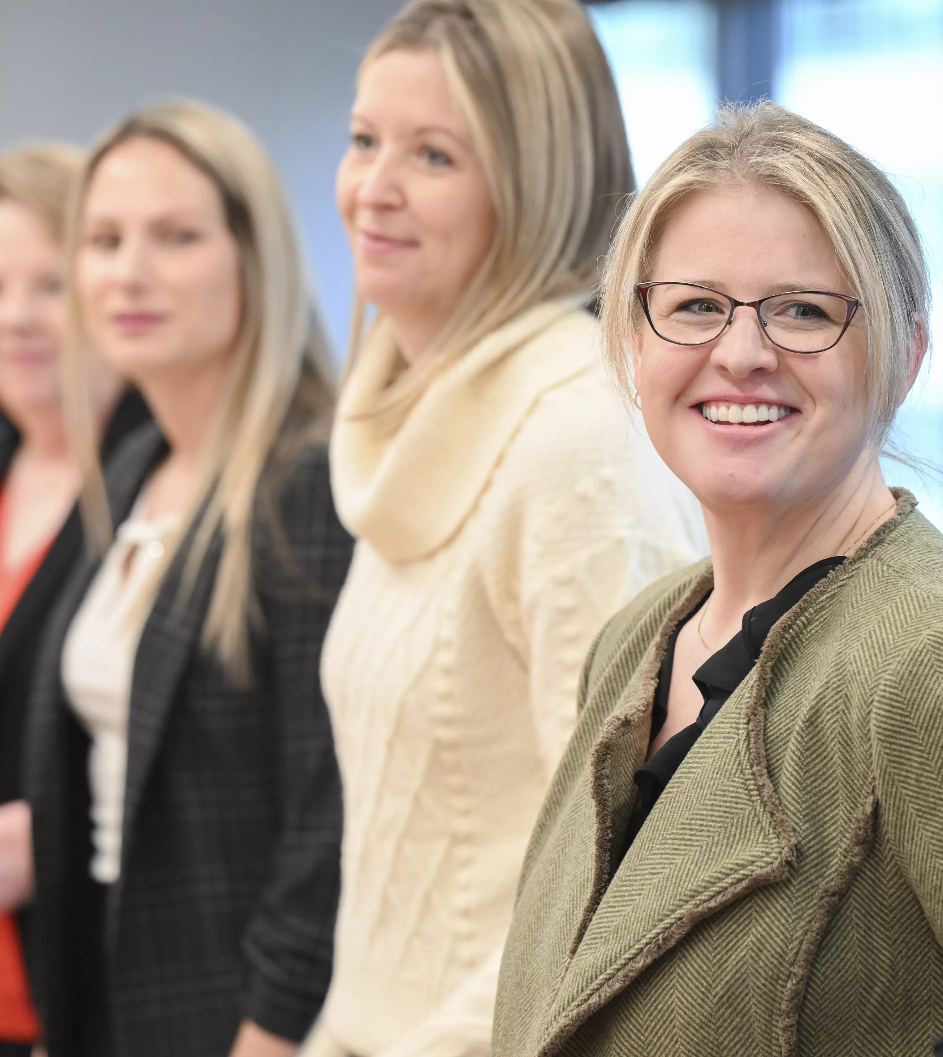 Employee smiles at camera during a meeting.