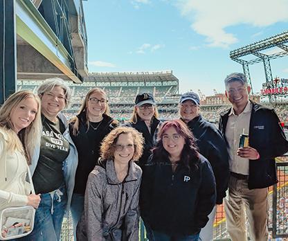 PI team poses while at a Mariners game.